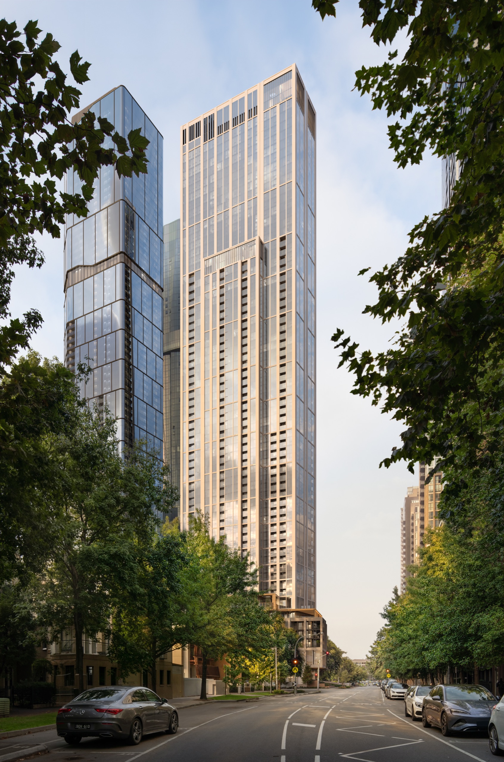AURA tower rising on the boulevard at golden hour